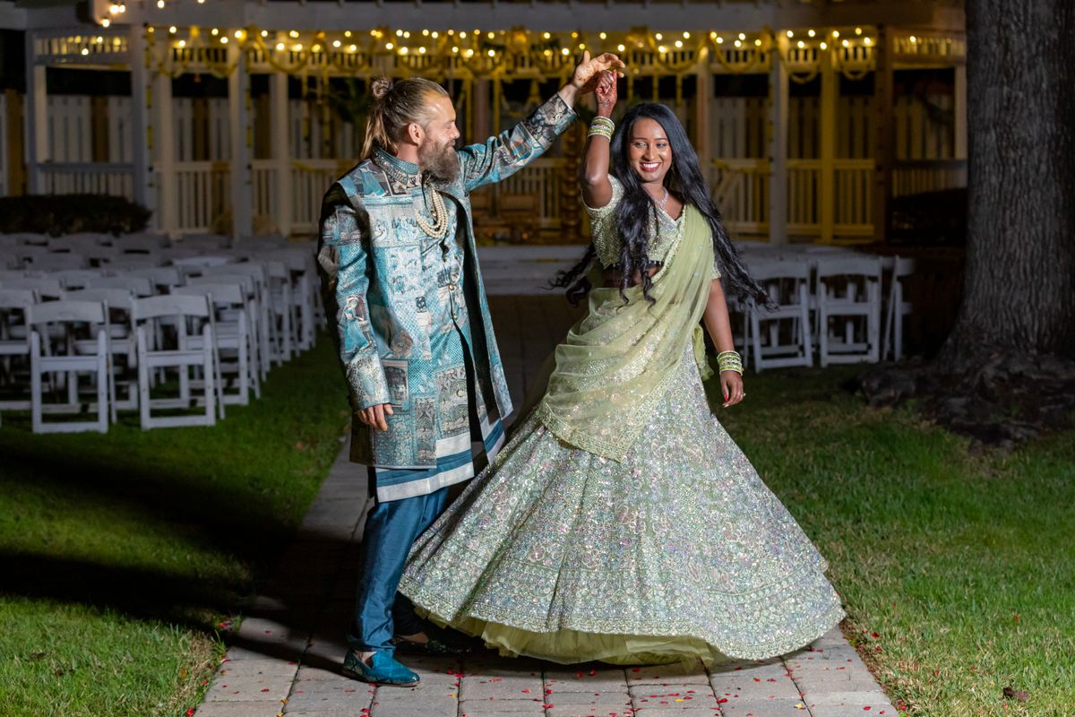A couple dancing together at an outdoor wedding night